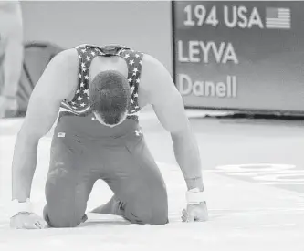  ?? Dmitri Lovetsky / Associated Press ?? Danell Leyva attempts to gather himself after a fall from the high bar that was one of numerous mistakes that doomed the U.S. to a fifth-place finish Monday.