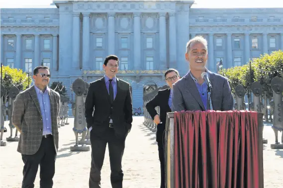  ?? Courtesy Civic Center Community Benefit District ?? Artist Zak Ové, who lives in London and hadn’t visited San Francisco before the installati­on of his work, speaks in front of his sculptures in Civic Center Plaza.