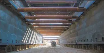  ??  ?? WORKERS on the project continue to excavate underneath California Highway 180 outside downtown Fresno.