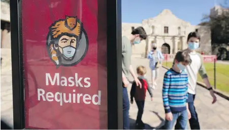  ?? ERIC GAY, THE ASSOCIATED PRESS ?? Visitors wearing face masks leave the Alamo on Wednesday in San Antonio, Texas.