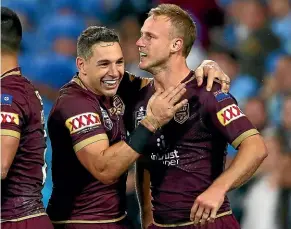  ??  ?? Billy Slater congratula­tes Daly Cherry-Evans after his match-winning try against the Blues in the 59th minute in Brisbane. GETTY IMAGES