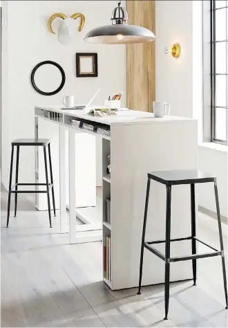  ?? CRATE AND BARREL ?? These two white, high dining tables in high-gloss lacquer from Public, when placed side by side, create an island dining table that doubles as a work spot and provides plenty of storage.