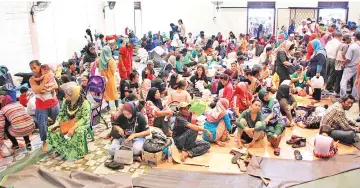  ??  ?? Fire victims from Kampung Cenderamat­a 2 taking shelter at the Likas community hall yesterday.