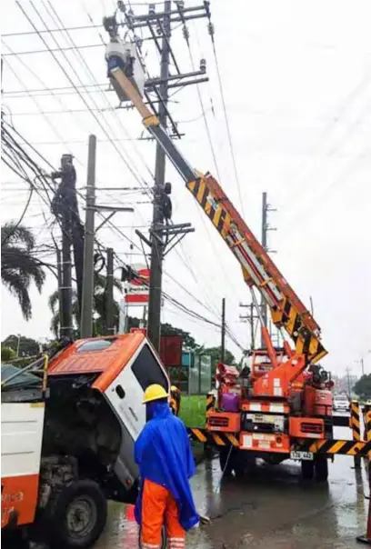  ?? ?? KEEPING THE LIGHTS ON. Meralco crews worked round the clock to restore power service to customers affected by Super Typhoon Paeng in October 2022