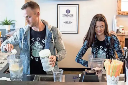  ??  ?? Co-owners Seth Mcmurry, left, and Cymber Mcmurry make drinks while working at Nutrition Hub at 9087 Poplar Ave. in Germantown. Nutrition Hub serves meal-replacemen­t shakes, aloe shots and energy teas. BRAD VEST/THE COMMERCIAL APPEAL