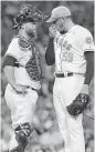  ?? Yi-Chin Lee / Houston Chronicle ?? Limiting visits to the mound by catchers like Brian McCann, left, is one move being considered to speed up games.