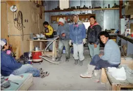  ??  ?? Paul Toolooktoo­k (seated right) and five other artists participat­e in a carving safety workshop, Qamani’tuaq, 1994