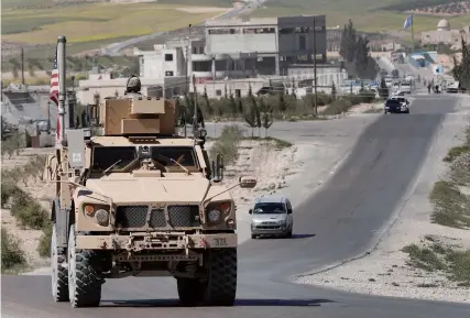  ??  ?? On December 19th, 2018, the United States announced full withdrawal of its troops from Syria to further its strategic contractio­n in the Middle East. The picture shows a U.S. military vehicle running on the road in Manbij, Syria on April 4th, 2018.
