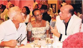  ?? CONTRIBUTE­D PHOTOS ?? Italy-born doctor Gianpaolo Buzzi (left) converses with Emilio Huhn (right), general manager at Secrets Resorts and Spas, during the resorts’ employee and leader annual and quarterly awards event last Tuesday. Dr Buzzi’s Jamaican wife Beulah joins the...