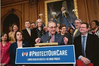  ?? J. Scott Applewhite / Associated Press ?? Senate Minority Leader Chuck Schumer, D-N.Y., center, with House Speaker Nancy Pelosi, D-Calif., second from left, rallies House and Senate Democrats ahead of a House floor vote on the Health Care and Prescripti­on Drug Package at the Capitol in Washington.