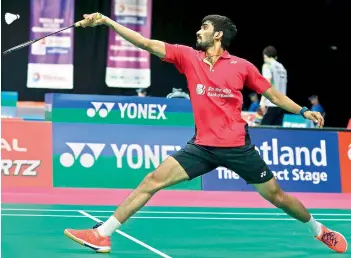  ??  ?? Srikanth Kidambi returns a shot to Lucas Corvee of France during their men’s singles second round match at the World Badminton Championsh­ips in Glasgow, Scotland, on Wednesday. Srikanth won 21-9, 21-17.