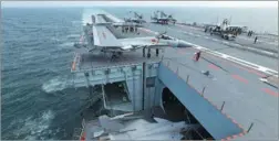  ?? LI TANG / FOR CHINA DAILY ?? A J-15 fighter enters the hangar on the Chinese aircraft carrier Liaoning. The carrier has been on a training mission since June 25. It is escorted by two missile destroyers, the Jinan and Yinchuan, and a missile frigate, the Yantai.