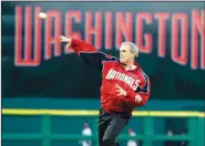  ?? AP File Photo ?? President George W. Bush throws out the ceremonial first pitch at the Washington Nationals home opener in Washington on April 14, 2005.