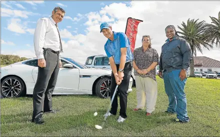  ?? Picture: MARK WEST ?? HOW IT’S DONE: Checking out Humewood PGA club profession­al Brendon Timm’s chipping style are, from left, Waldo Orban, of Jaguar Land Rover Eastern Cape, Michelle Mclean, of the Nkosinathi Foundation, and Mio Khondleka of AlgoaFM