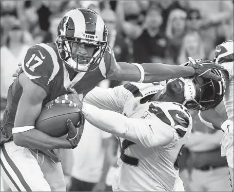  ?? Wally Skalij Los Angeles Times ?? RAMS RECEIVER Robert Woods stiff-arms Seattle safety Delano Hill to pick up 35 yards on a pass from Jared Goff in the third quarter.