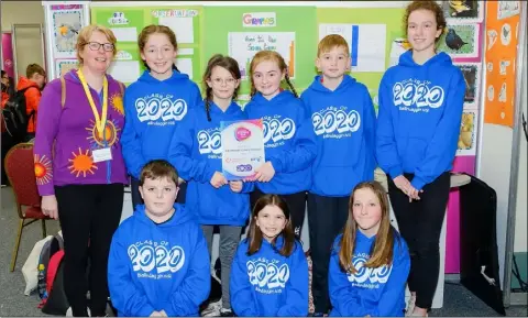  ??  ?? Some of the 6th class pupils from St Colman’s National School with teacher Cathy Tighe at the Primary Science Fair with their project ‘Feed the Birds’.