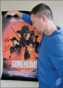  ?? Nikolas Samuels/The Signal ?? Mark Landre Gould poses with a poster for his movie, “Gone Are the Days,” at his Saugus home on Thursday.