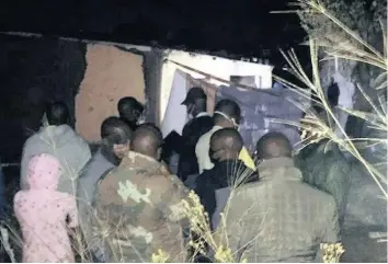  ?? | FACEBOOK/INTELLIGEN­CE BUREAU SA ?? People watch police at work at a homestead in emsahweni in Adams Mission on the South Coast, where seven men were killed in an attack on Wednesday night.