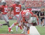  ?? BARBARA J. PERENIC/COLUMBUS DISPATCH ?? Oregon running back CJ Verdell is tackled by Ohio State safety Bryson Shaw as he scores a touchdown on Saturday.