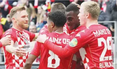  ?? Reuters ?? ↑
Mainz’ players celebrate after their victory over Bayern Munich in their German League match.