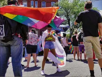  ?? Paul Buckowski / Times Union ?? Advocates and community members celebrate June 13 at the 2021 Capital Pride BBQ and Block Party outside of the Waterworks Pub and Rocks on Central Avenue in Albany.