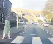  ??  ?? The woman begins to cross Burnley Road