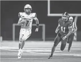  ?? MATT STONE/COURIER JOURNAL ?? Lexington Christian’s Cutter Boley scrambles for yardage from CAL’s Nathan Ehrenborg in the fourth quarter in Louisville on Sept. 8.