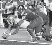  ?? Timothy D. Easley Associated Press ?? CLEMSON quarterbac­k Kelly Bryant is brought down by a host of Louisville defenders in the first half.