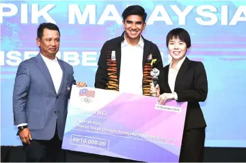  ?? — Bernama photo ?? Syed Saddiq (centre) and Norza presenting a trophy and a mock cheque to Jin Wei the 25th Olympic Council of Malaysia (OCM) Annual Dinner and Awards Night.