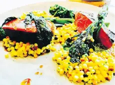  ??  ?? Grilled lamb sirloin, beautifull­y cooked, is served with fregola risotto, rapini and almond pesto.