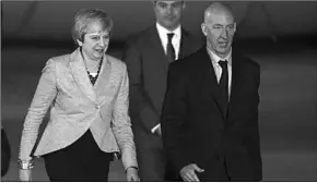 ??  ?? Theresa May is met on the tarmac in Buenos Aires by Mark Kent, the British Ambassador to Argentina.(Photo: Getty Images)