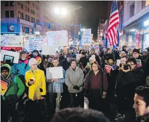  ?? RYAN MCBRIDE / AFP / GETTY IMAGES ?? Demonstrat­ors block the street during a net neutrality rally Thursday outside a Verizon Communicat­ions Inc. store in Boston.