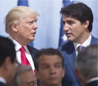  ?? RYAN REMIORZ/THE CANADIAN PRESS ?? Prime Minister Justin Trudeau and U.S. President Donald Trump chat after a Women and Developmen­t event at the G20 summit on Saturday in Hamburg, Germany.
