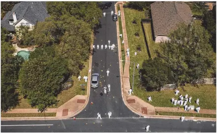  ??  ?? ABOVE: Investigat­ors work at the scene of the bombing on Dawn Song Drive in Southwest Austin on Monday.