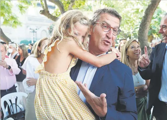  ?? EFE ?? El presidente del PP, Alberto Núñez Feijóo, abrazado ayer por una niña en un acto que el partido celebró en Zaragoza.