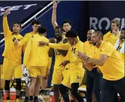  ?? CARLOS OSORIO — THE ASSOCIATED PRESS ?? The Michigan bench reacts after a play during the first half of a college basketball game against Michigan State on Thursday in Ann Arbor.