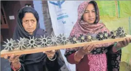  ?? PTI ?? Women show mortar shells after the crossborde­r shelling in R S Pura Sector, Jammu, on Sunday.