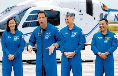  ?? JOE BURBANK/ORLANDO SENTINEL ?? European Space Agency astronaut Thomas Pesquet, second from left, jokes as NASA astronauts Megan McArthur, left, and Shane Kimbrough, and Japanese astronaut Akihiko Hoshide, right, respond while answering questions after their arrival at Kennedy Space Center on Friday ahead of the SpaceX Crew-2 launch to the Internatio­nal Space Station scheduled for Thursday.