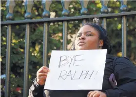  ?? SHELBY LUM/RICHMOND TIMES-DISPATCH ?? Zyahna Bryant of Charlottes­ville holds a sign at a protest last week after racially charged photos surfaced from Governor Ralph Northam’s medical school yearbook.