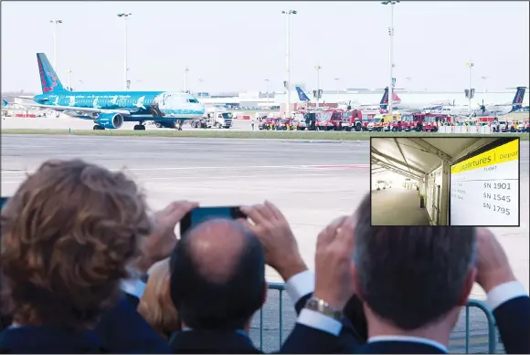  ??  ?? People take pictures of the first flight after the reopening of Brussels Airport, from Zaventem towards Faro on April 3. Brussels Airport reopened today with three ‘symbolic’ flights and strict additional checks for passengers, marking a new...