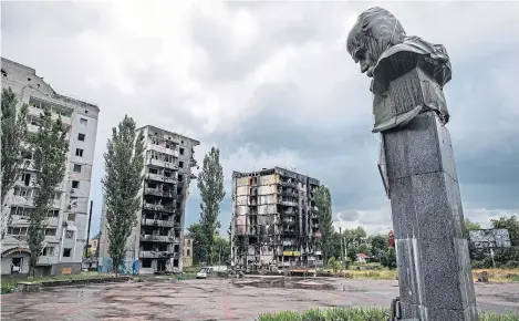  ?? ?? A damaged statue of Ukrainian poet Taras Shevchenko standing amid shelled buildings in Borodianka, near Kyiv.