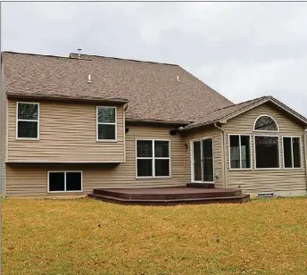  ??  ?? Sliding doors off the morning room open to a composite deck and fenced backyard.