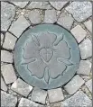  ??  ?? The Luther family crest can be found in the cobbleston­e streets of Eisleben, where the religious reformer was born and died.