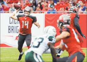  ?? Steve Nesius / Associated Press ?? Buccaneers quarterbac­k Ryan Fitzpatric­k (14) throws a pass against the Jets during the first half Sunday in Tampa, Fla.