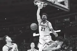  ?? Ron Chenoy, USA TODAY Sports/Reuters ?? DENVER Nuggets guard Jamal Murray (27) finishes off a basket over Milwaukee Bucks forward D.J. Wilson (5) in the third quarter at the Pepsi Center.