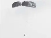  ?? JOE RAEDLE Getty Images | TNS ?? Blue Origin’s New Shepard crew capsule descends on the end of its parachute system Tuesday in Van Horn, Texas.