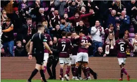  ?? Photograph: Andrew Milligan/PA ?? Hearts’ Lawrence Shankland (centre right) is mobbed by his teammates after scoring the second goal against Celtic.