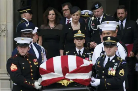  ?? SUSAN WALSH — THE ASSOCIATED PRESS ?? The casket of Sen. John McCain, R-Ariz., is carried out of the Washington National Cathedral in Washington, Saturday after a memorial service, as Cindy McCain is escorted by her son Jimmy McCain and other family members.