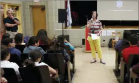  ?? MARTHA IRVINE — THE ASSOCIATED PRESS ?? Dawn Iles-Gomez, principal at Nathan Hale Elementary School, speaks to some of her students in Chicago on Friday. She often speaks about her dislike of social media and the impact it has on her students’ lives. “It’s shocking — the language and the threats and the mean things that are said (on social media),” she says. And she says often parents have no clue or would rather not deal with it.