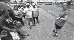  ?? ROGELIO V. SOLIS/AP ?? Gabriela Rosales, right, confers with friends Thursday outside the employee entrance to the Koch Foods Inc., plant in Morton, Miss. Federal agents raided the plant Wednesday.